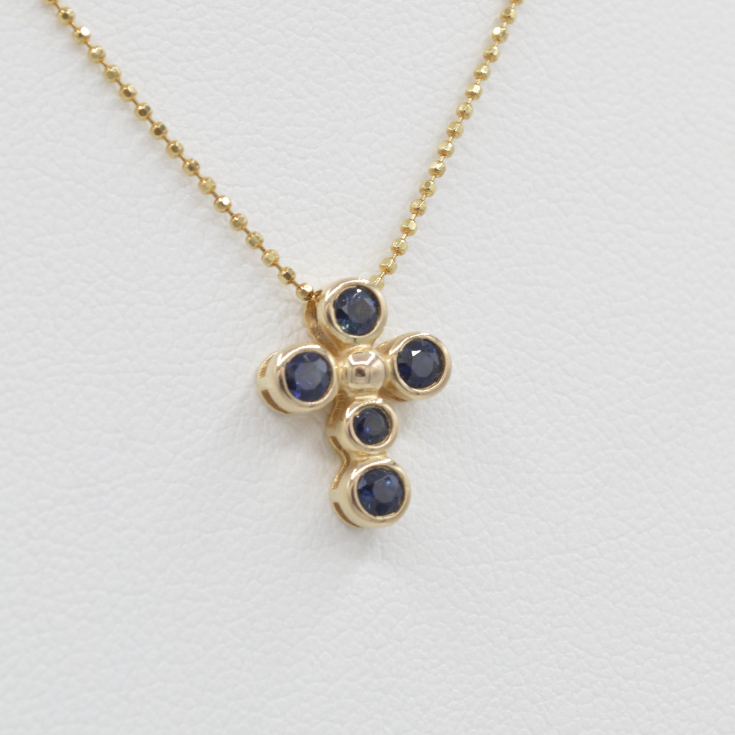 Dainty Sapphire Bezel Cross